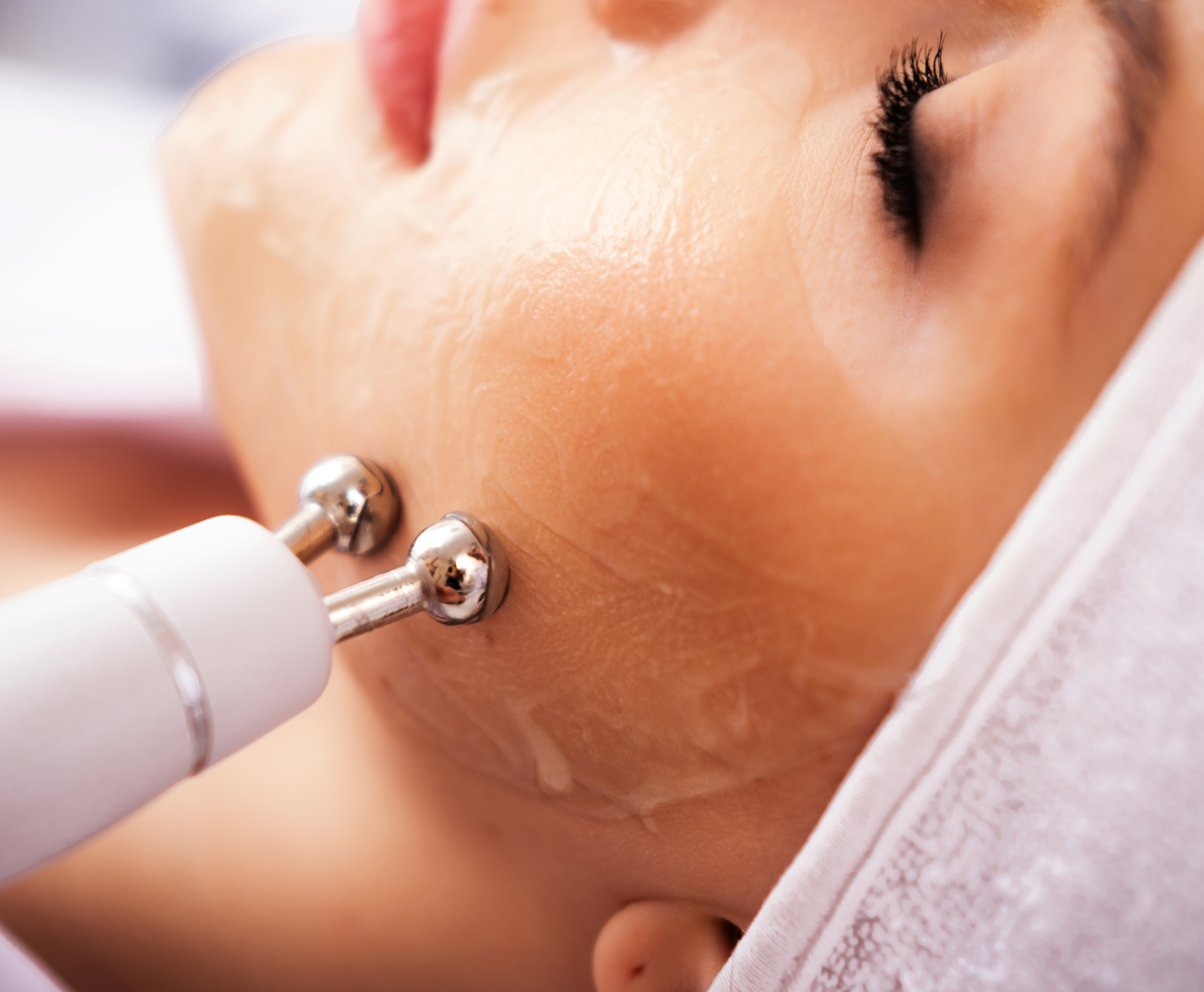 Close-up of a woman receiving a facial micro-sculpting treatment with a syringe, highlighting precision and care.